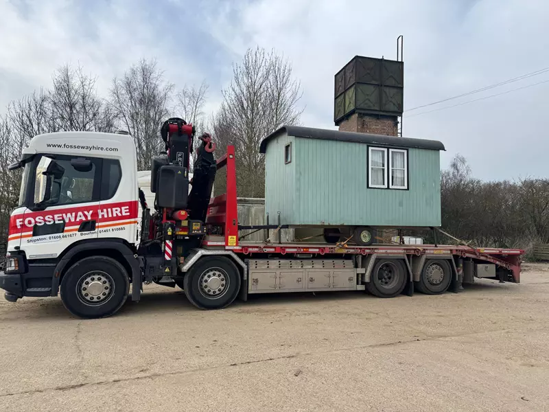 crane shepherds hut on to lorry